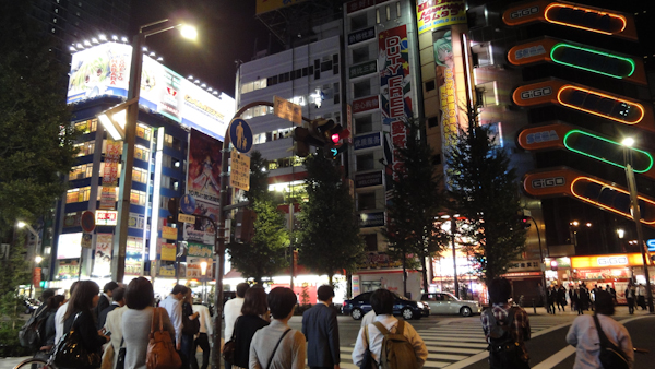 colourfully lit buildings above a crowd